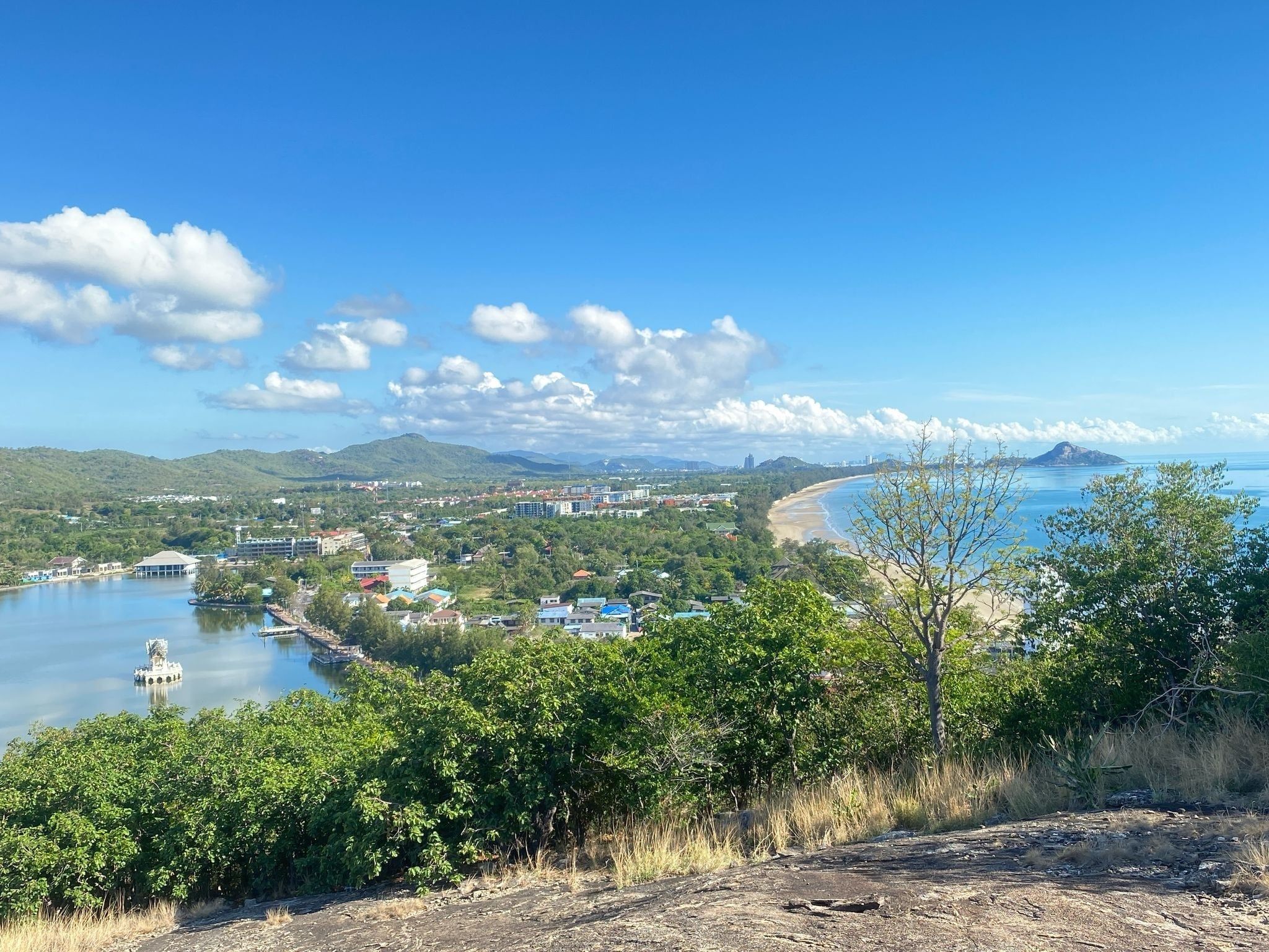 View from a green hilltop over Hua Hin and the curve of the coast