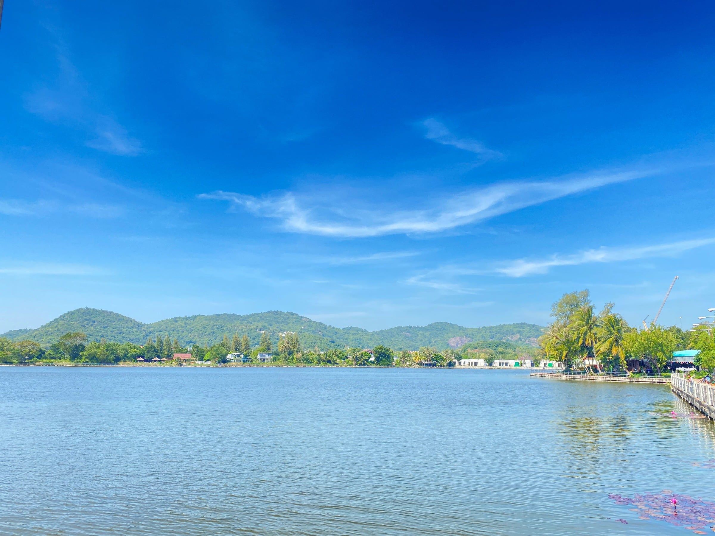 The Khao Tao reservoir and green hills under a blue sky, a short walk from The White Room